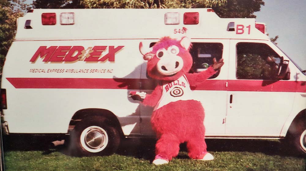 Benny the Bull standing in front of the first Medex Ambulance